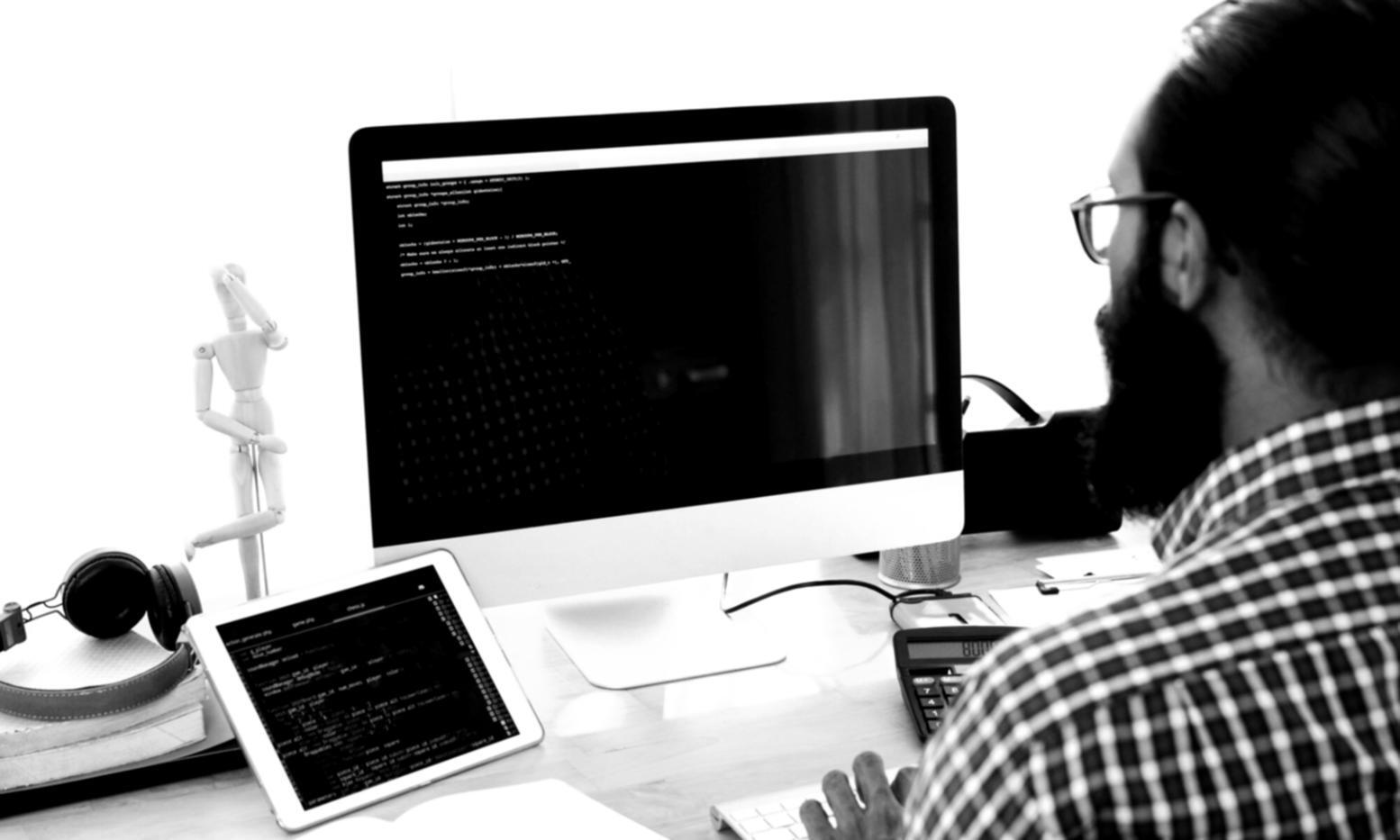 Students working on interface design projects in collaborative workspace